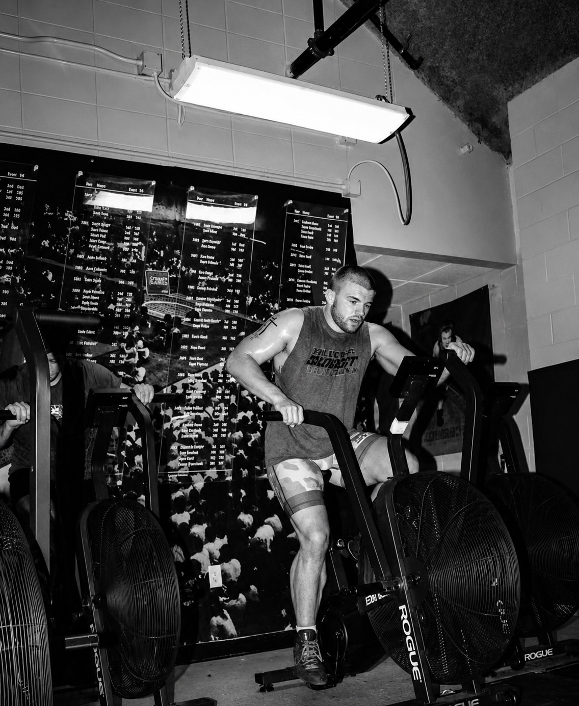 Athlete grinding on an assault bike in the gym